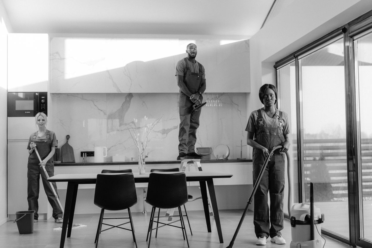The Art of Drawing Readers In: Your attractive post title goes here A team of professional cleaners working in a modern dining room setting, enhancing interior cleanliness.